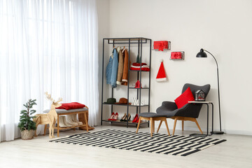 Interior of hallway with Christmas presents, coat rack and armchair