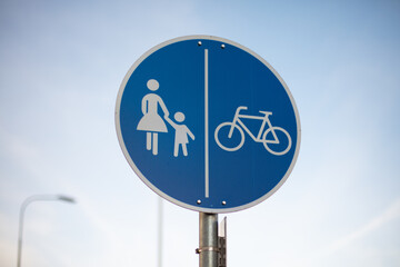 Shared cycle pedestrian route sign, close up, day. Sunlight, outside.
