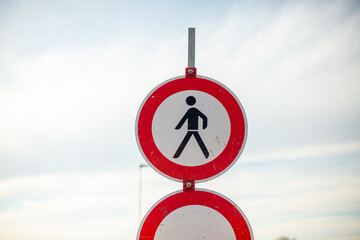 Pedestrian prohibition sign on sunny road.