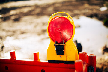 Construction warning light on sunny day outdoors.

