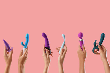 Women with vibrators and anal plug on pink background