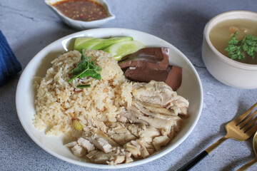 Rice steamed with chicken soup and dipping sauce or Khao Mun Kai in white plate. thai food concept.