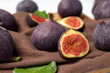 Fresh ripe figs on a cloth on a light background