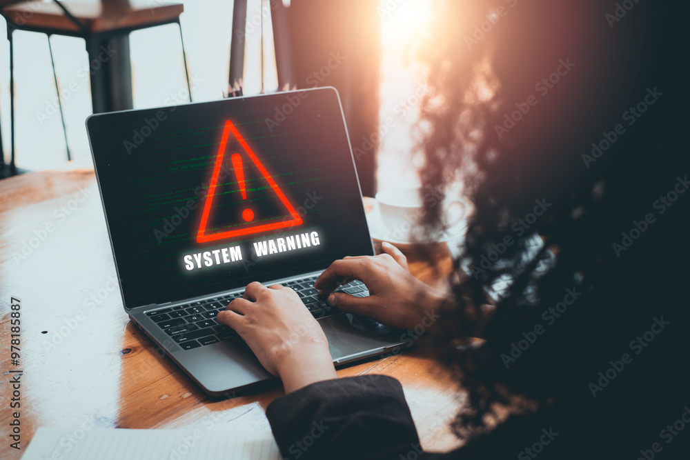 Poster person using laptop with system warning hacked alert concept displayed on screen, highlighting cyber