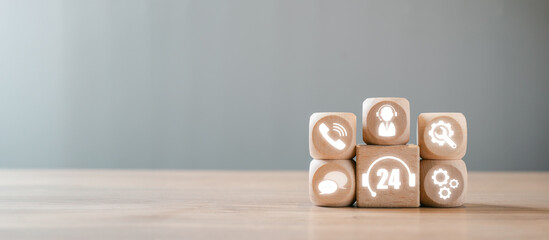 Wooden blocks with icons representing 24/7 customer support and continuous service, illustrating the concept of non-stop service.
