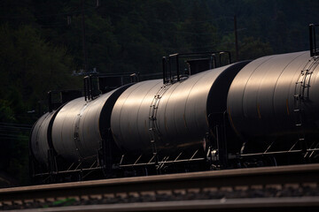 Black tank cars cisterns for gas and oil, captured in Portland, Oregon industrial area. High quality close up picture for download.