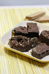 Chocolate pudding on white plate with woven tablecloth isolated