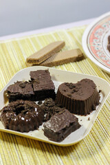 Chocolate pudding on white plate with woven tablecloth isolated