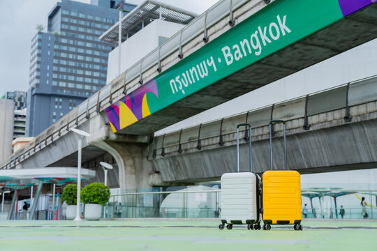 Two suitcases in Sky walk of MBK Shopping Center.Famous destinations in Bangkok,Thailand, Landmark Tourism advertising logo on BTS sky train track, Thai word translation : Bangkok, vacation concept.