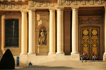 Paris, Ille de France, France. September 16, 2024: People visiting the entrance of a historic building in Paris during daytime
