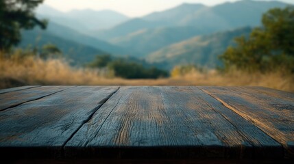 A wooden table in the foreground with a blurred mountain landscape in the background.