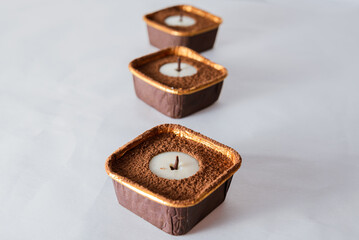 Candle-shaped dessert with chocolate and nuts
