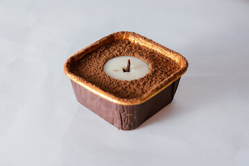Candle-shaped dessert with chocolate and nuts
