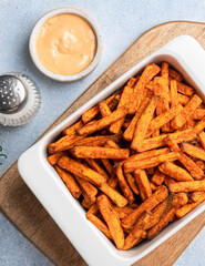 Baked sweet potato in white baking dish, top view, close up