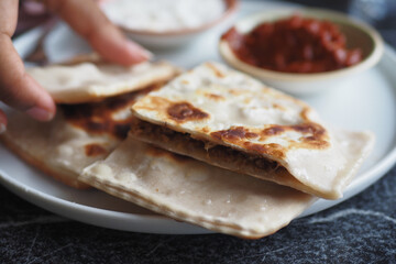 A Plate of Delicious Flatbreads Accompanied by Tasty Dips and Condiments for Enjoyment