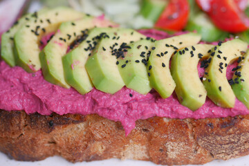  sandwich with avocado and hummus on plate