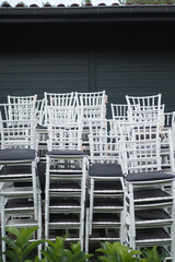 Neatly Stacked White Chairs Are Ready and Available for Event Usage and Arrangements