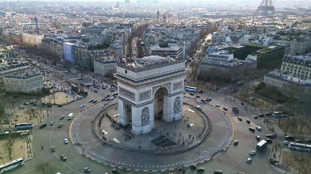 Sideways aerial movement around the Arc de Triomphe with heavy traffic, Paris, France.