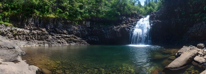 Naklejka premium 32. **A picturesque waterfall cascading down a rocky cliff into a clear pool below. The surrounding forest is lush and vibrant.