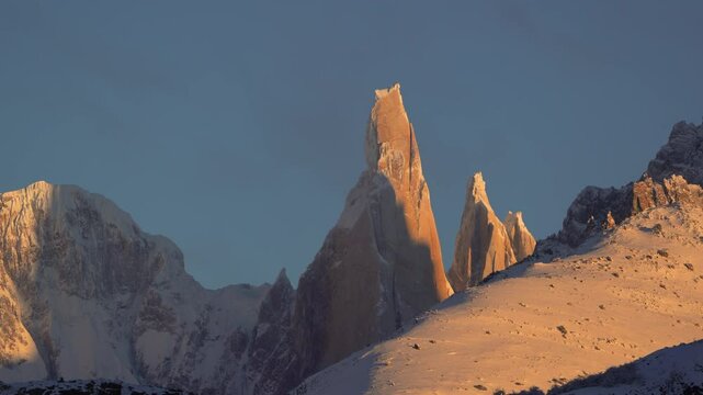 Cloud slowly cover and uncover Cerro Torre and Adela Mountain range in Patagonia, El Chalten, Argentina, in winter. Static zoomed in view