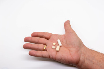 Vitamins and medicinal pills held in hand, symbol of health and wellness, copy space, selective focus.