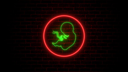 Neon, glowing human embryo. Human Cloning. Human fetus baby concept on brick wall.