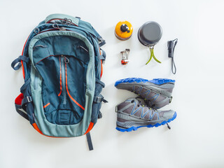 Hiking gear and camping equipment for travel on white background.