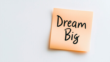 Sticky Note: A single peach-colored sticky note with the words "Dream Big" written in simple, clear handwriting. The sticky note is on a plain white background, encouraging ambition and optimism.


