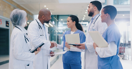 Woman, doctors and handshake with group in hospital corridor with welcome, introduction and happy....