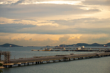 Fototapeta premium Logistic shipping quay boat in twilight sky night Engineering crane depot at logistic export terminal control. Warehouse freight background container yard loading quayside harbor port Logistics.