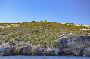 Zakynthos August 2024, amazing multicolored and surprising landscapes and the lighthouse and flag of Greece