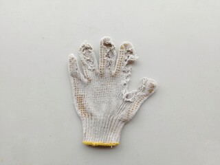 The gloves were dirty and damaged on his fingers in white and yellow, with a white background.