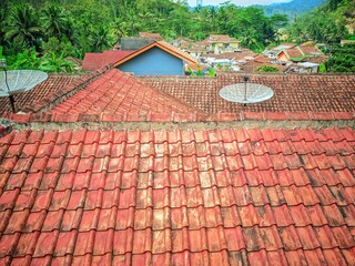 View of the roof tiles of a house that has been installed for a long time from a height. Densely...