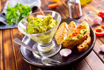 Traditional latinamerican mexican sauce guacamole in bowl