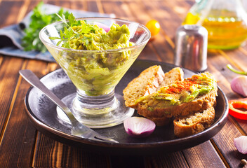 Traditional latinamerican mexican sauce guacamole in bowl