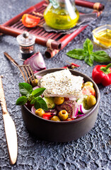Greek salad with tomatoes, feta cheese, cucumbers, onions and olives