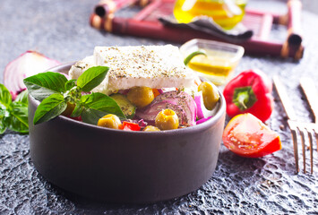 Greek salad with tomatoes, feta cheese, cucumbers, onions and olives