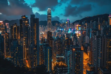 Fototapeta premium A vibrant cityscape at night showcasing illuminated buildings and a dramatic sky.