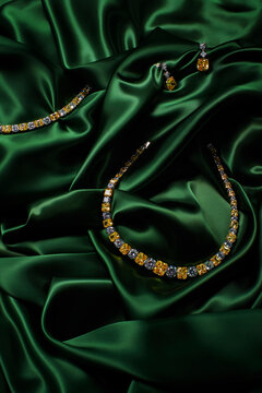 Gold necklace, earrings and bracelet with gemstones and diamonds