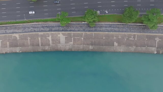 Top down aerial footage panning across the Lakefront Trail in downtown Chicago with a group of runners exercising.
