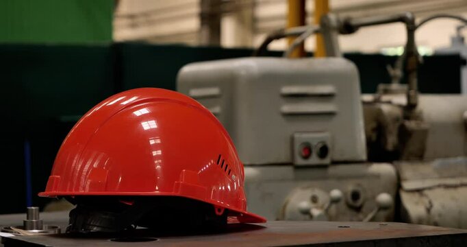 Hemlet lies on the machine table at the factory assembly line. 