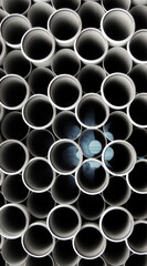 Dark gray plastic tubes in a stack vertical stock photo 
