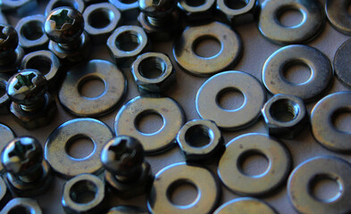 Shiny Bolts, Nuts And Washers Laid Out Side By Side On White Surface Macro Shot Stock Photo