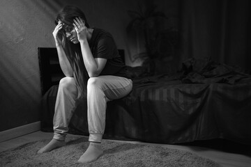 Depressed woman suffering from headache at night