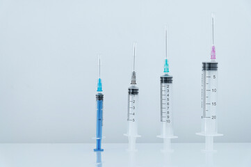White background image of medical syringes and masks