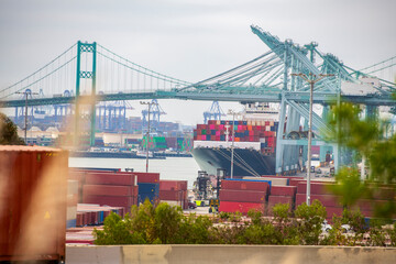 View on ships and shipping containers in port at Long Beach Harbor