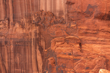 Close-up of red rock cliff face with natural patterns and erosion