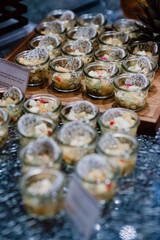 Mini fruit salads with dragon fruit displayed on a dessert buffet.