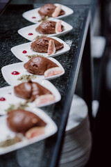 Plated chocolate mousse with figs and decorative garnish in a buffet