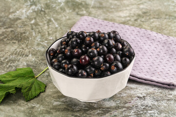 Ripe black currant in the bowl